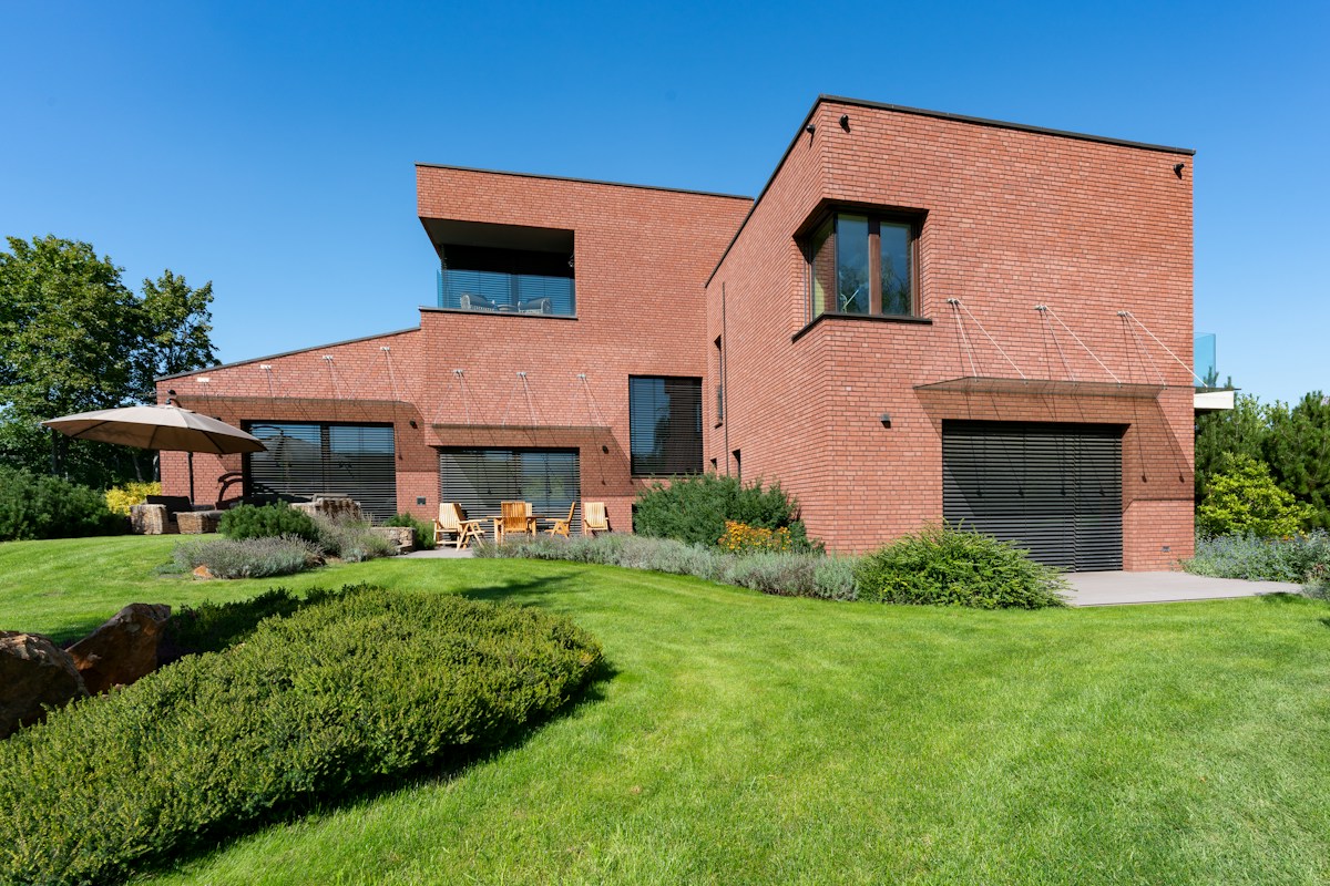 Brick house used in the fictional Ridge & Row roofing website design